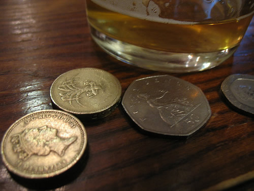 Copo de cerveja e moedas